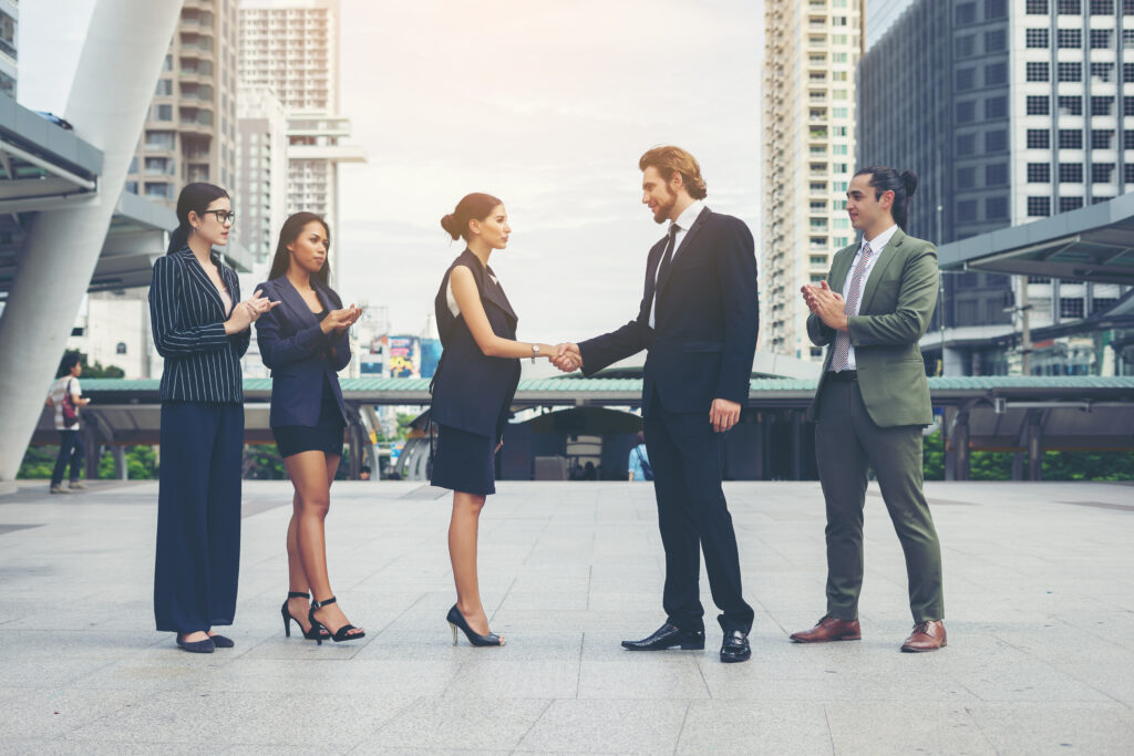 Two leaders shaking their hands at a Leadership Conference