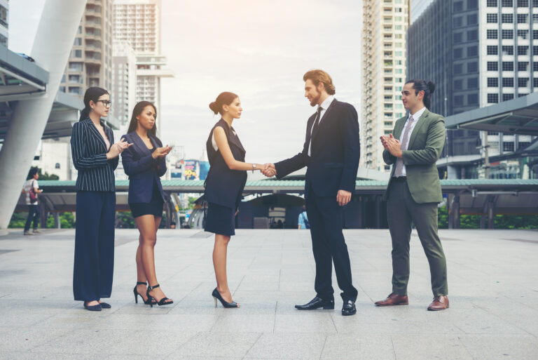 Two leaders shaking their hands at a Leadership Conference