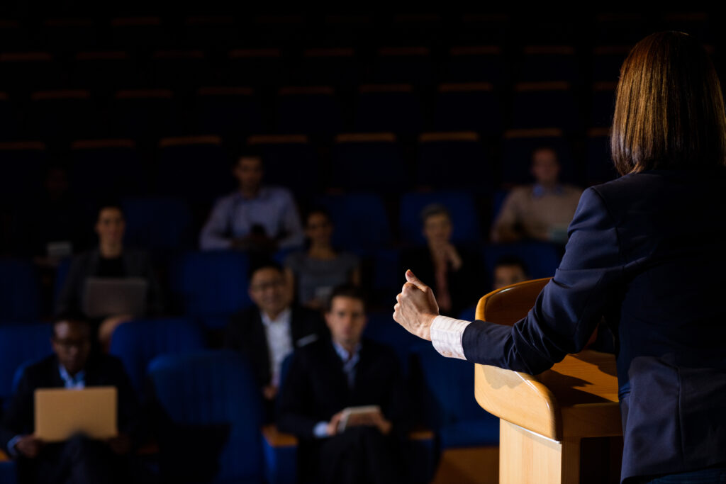 female business executive giving speech at a leadership conference