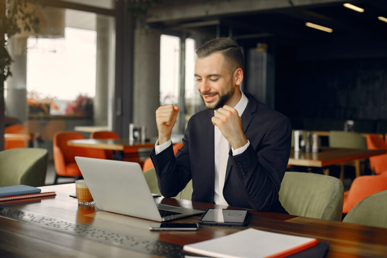 Businessman working in cafe and smiling